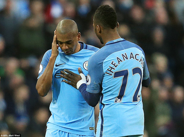 Manchester City forward Kelechi Iheanacho (right) consoles a dejected Fernandinho as the Brazilian makes his way off